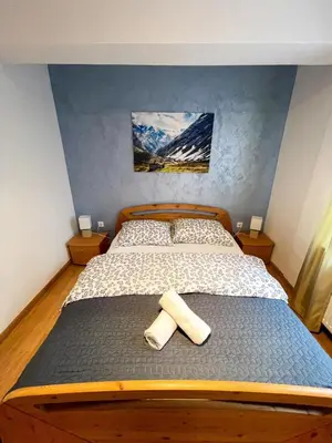 a bedroom with a bed with two towels on it at Apartment Love in Vlasic