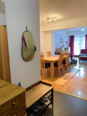 a dining room and living room with a table and chairs at Apartment Love in Vlasic