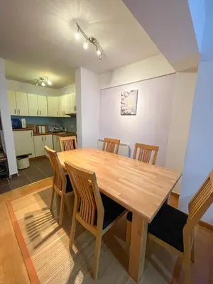 a dining room with a wooden table and chairs at Apartment Love in Vlasic