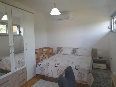 a small bedroom with a bed and a mirror at Villa Al Nemah in Bihać