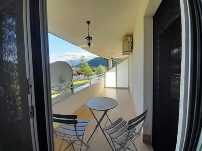 a table and chairs on a balcony with a view at Villa Al Nemah in Bihać