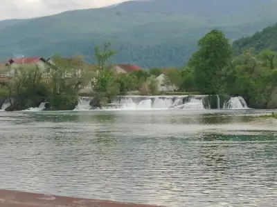 a waterfall in the middle of a body of water at Villa Al Nemah in Bihać