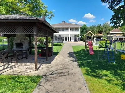 a pavilion with a picnic table and a playground at Villa Al Nemah in Bihać