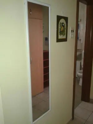 a bathroom with a mirror next to a toilet at Apartment 3M in Banja Luka