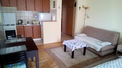 a small living room with a couch and a kitchen at Apartment 3M in Banja Luka