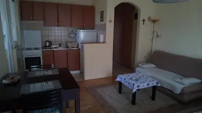 a small living room with a couch and a kitchen at Apartment 3M in Banja Luka