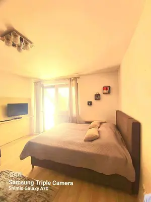 a bedroom with a large bed with a window at Vlašićka priča Eko Fis in Vlasic