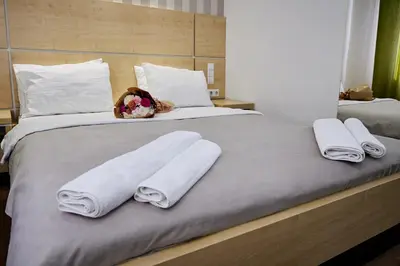 a large bed with two towels on top of it at Laurus Motel Airport Tuzla in Živinice