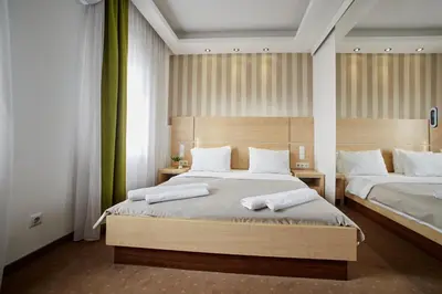 a bedroom with two beds with white pillows at Laurus Motel Airport Tuzla in Živinice