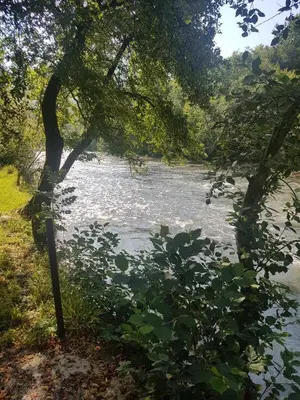 a body of water with trees and a river at Eden Visoko in Visoko