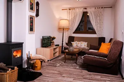 a living room with a couch and a fireplace at Eden Visoko in Visoko