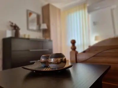 two bowls on a tray on a table next to a bed at Orhidea in Bihać