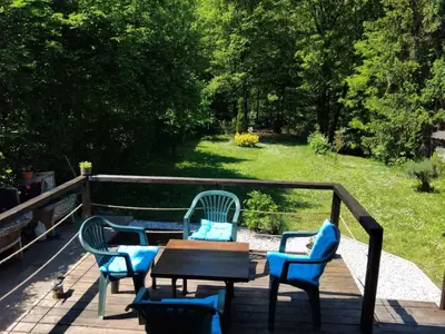 a table and chairs on a deck with a table and chairs at Tammaris Holiday Home in Visoko