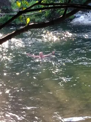 a man swimming in the water in a river at Tammaris Holiday Home in Visoko