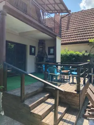 a deck with a table and chairs on a house at Tammaris Holiday Home in Visoko