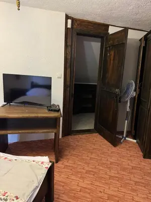a room with a door and a table and a mirror at Ski Rostovo - Hotel Rostovo & Ethno Village in Čardaci
