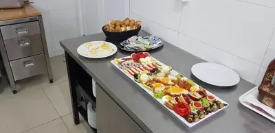 a kitchen counter with a tray of food on it at Ski Rostovo - Hotel Rostovo & Ethno Village in Čardaci