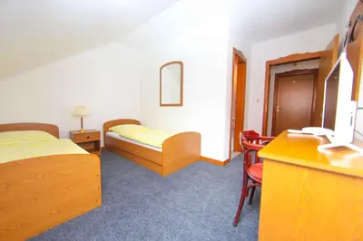 a hotel room with two beds and a table and chairs at Hard Rock Rooms for two in Livno