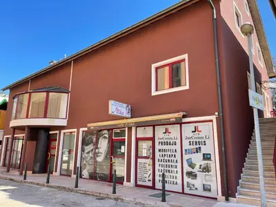 a brown building with a store on a street at Hard Rock Rooms for two in Livno