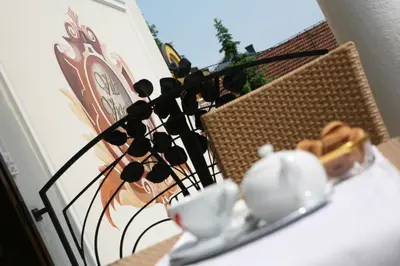 a table with a tea kettle and a cup on it at Hotel Villa Viktorija in Banja Luka