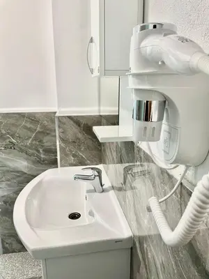 a bathroom with a white sink and a mixer at Apartman Nikolic,Banja Vrucica,Teslic in Teslić