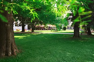 a park with green grass and trees and a building at Apartman Nikolic,Banja Vrucica,Teslic in Teslić
