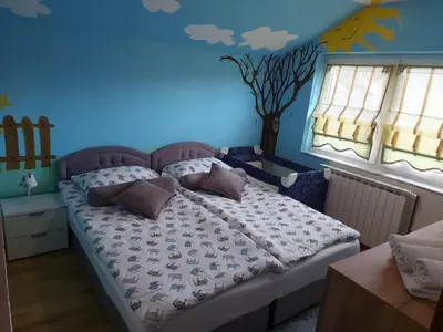 a bedroom with a bed with a tree painted on the wall at Luxury house 