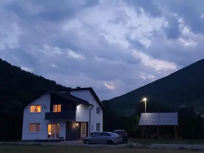a white house with a car parked in front of it at Luxury house 