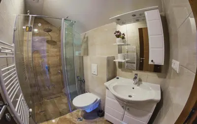 a bathroom with a sink and a shower and a toilet at Amal Grand Villa in Bihać