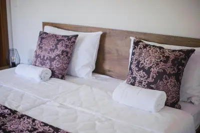 a bed with two pillows on top of it at Amal Grand Villa in Bihać