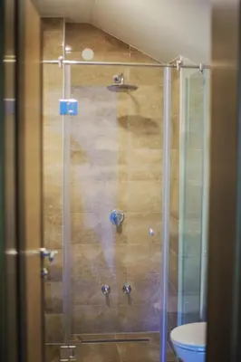 a shower with a glass door in a bathroom at Amal Grand Villa in Bihać