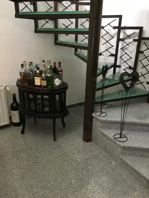 a table with bottles on it in a room at Luxeriöse Villa mit Bergblick in Donji Ljenobud