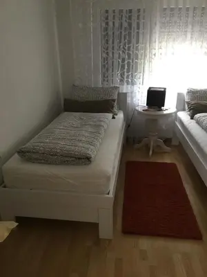 a bedroom with a bed and a table with a laptop at Luxeriöse Villa mit Bergblick in Donji Ljenobud