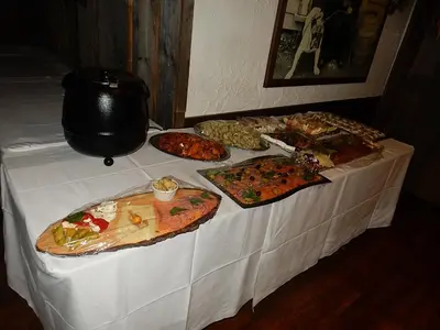 a table with many different types of pizzas on it at Luxeriöse Villa mit Bergblick in Donji Ljenobud