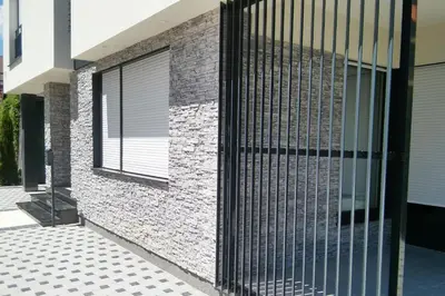 a metal gate on the side of a house at Villa Onix in Bihać