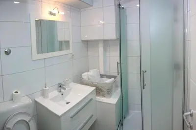a bathroom with a toilet and a sink and a shower at Villa Onix in Bihać