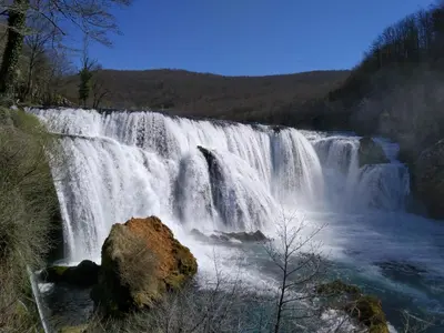 a large waterfall in the middle of a river at Seosko domacinstvo Halil & Alema in Ćukovi