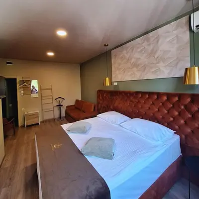 a bedroom with a large bed with a large headboard at Boutique Hotel St Georgije in Banja Luka