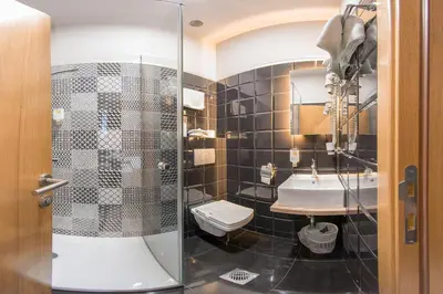 a bathroom with a shower and a toilet and a sink at Boutique Hotel St Georgije in Banja Luka