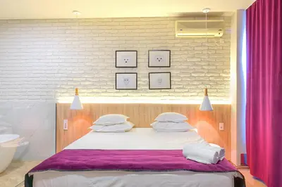 a bedroom with a large bed with white pillows at Boutique Hotel St Georgije in Banja Luka