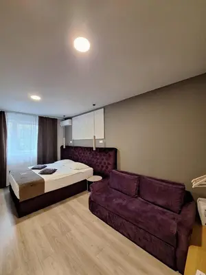 a bedroom with a bed and a couch at Boutique Hotel St Georgije in Banja Luka