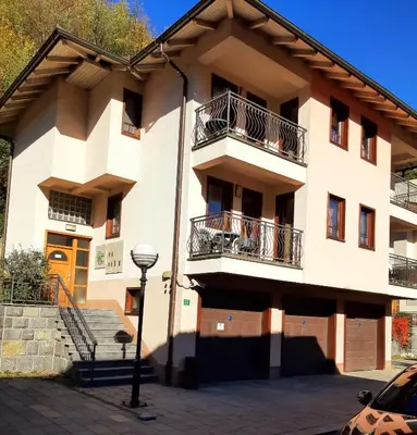 an apartment building with balconies and a street light at Relax Apartman sa garažom in Fojnica