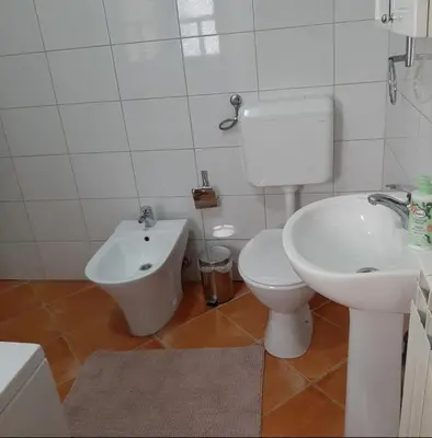 a bathroom with a toilet and a bidet and a sink at Relax Apartman sa garažom in Fojnica