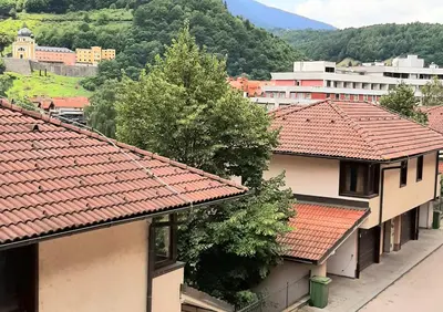 a group of buildings with red tile roofs at Relax Apartman sa garažom in Fojnica