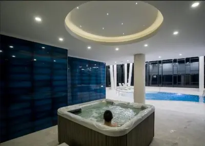 a man in a bath tub in a house at Relax Apartman sa garažom in Fojnica