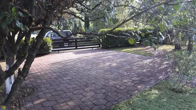 a brick walkway with a bench in a park at Hideaway in Bihać