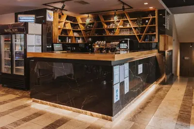 a bar in a restaurant with a black counter at Motel West in Zenica