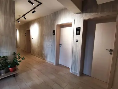 an empty hallway with two doors and potted plants at Motel West in Zenica