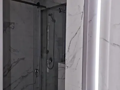 a bathroom with a shower with a glass door at Motel West in Zenica