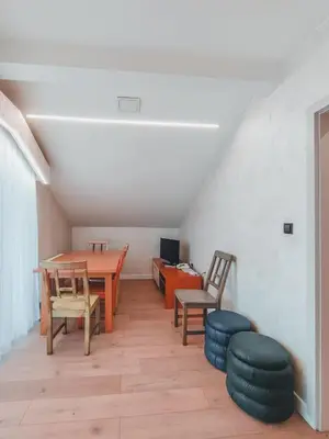 a room with a table and chairs and a desk at Motel West in Zenica